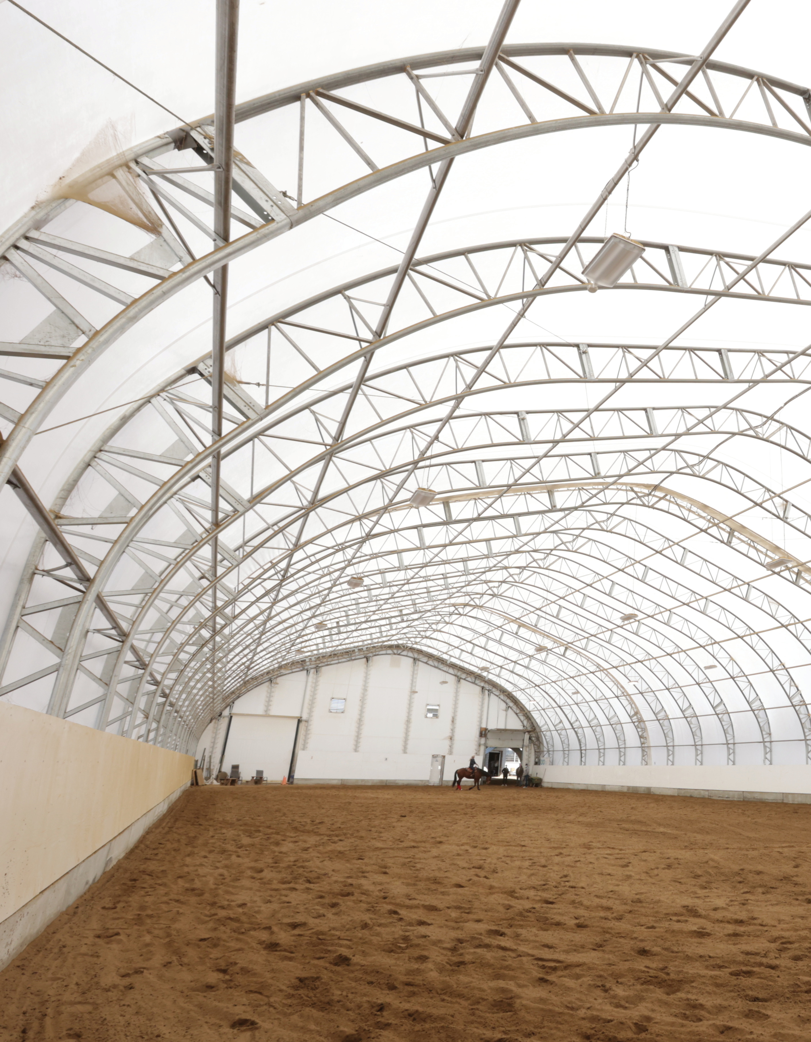 Fabric building interior showing engineered steel arch structure