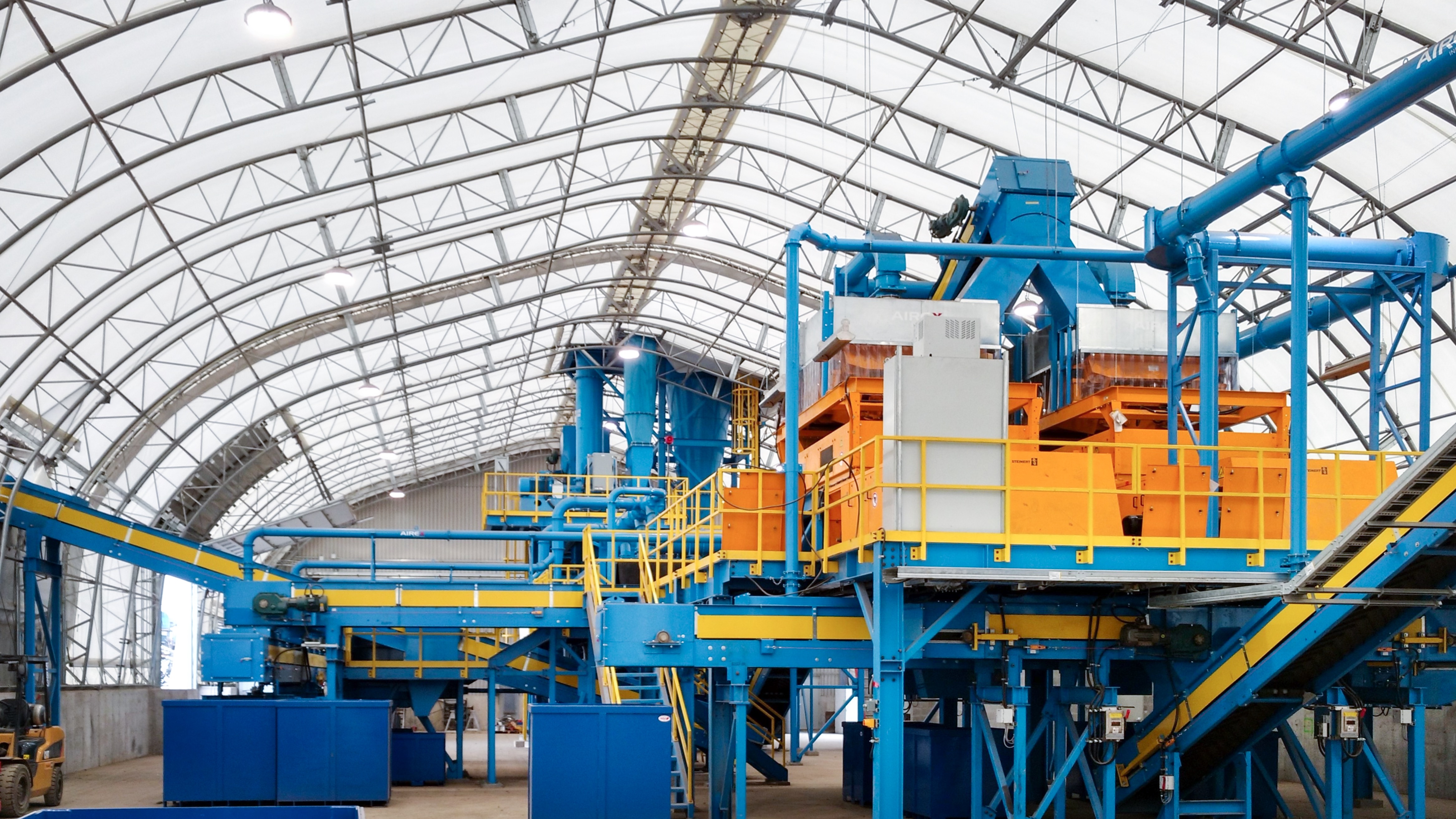 Heavy mining equipment housed inside a fabric building