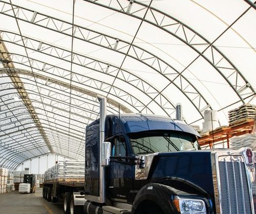 Heavy-duty PVC membrane and steel trusses inside a fabric building