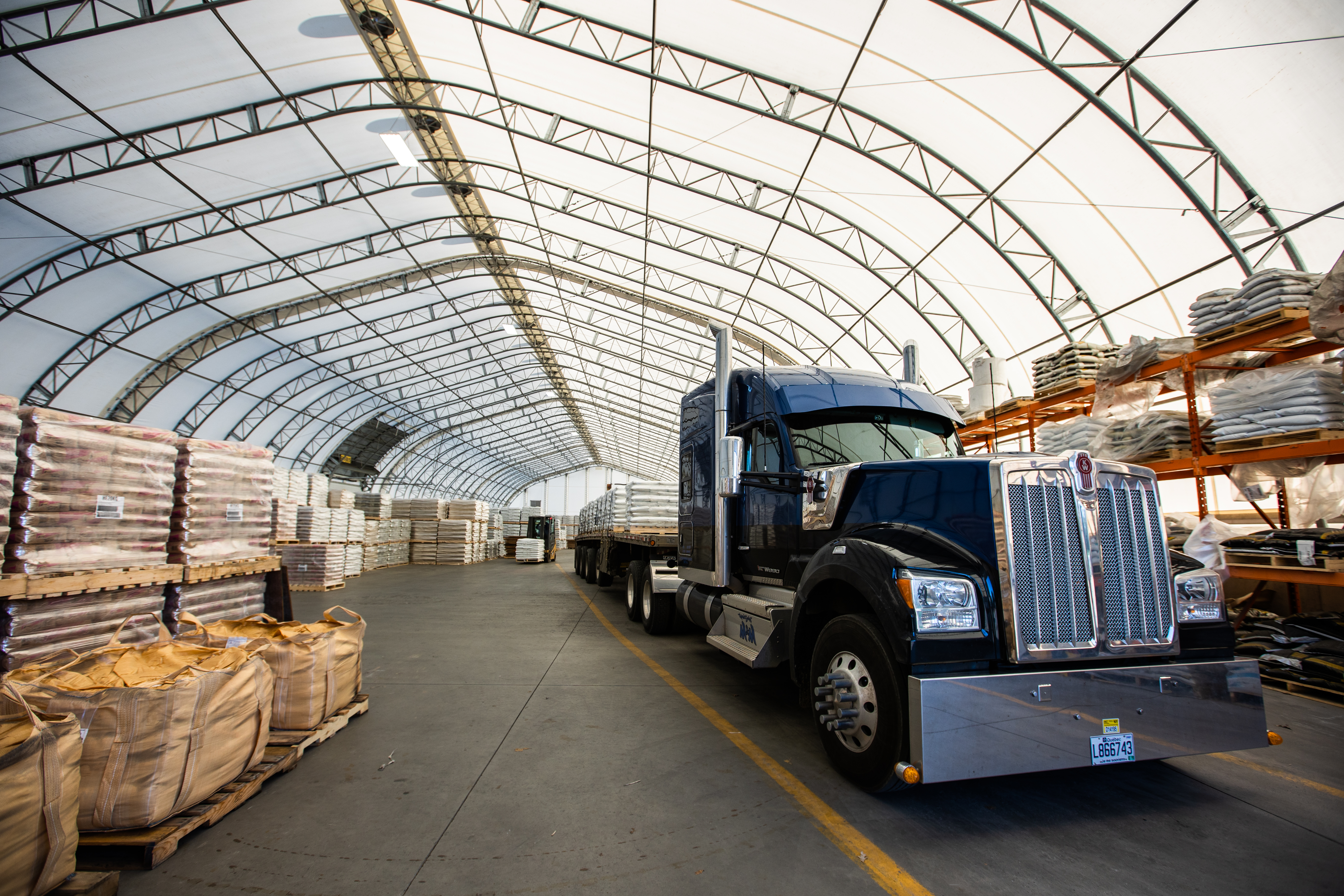 Semi-truck inside a clear-span fabric building warehouse